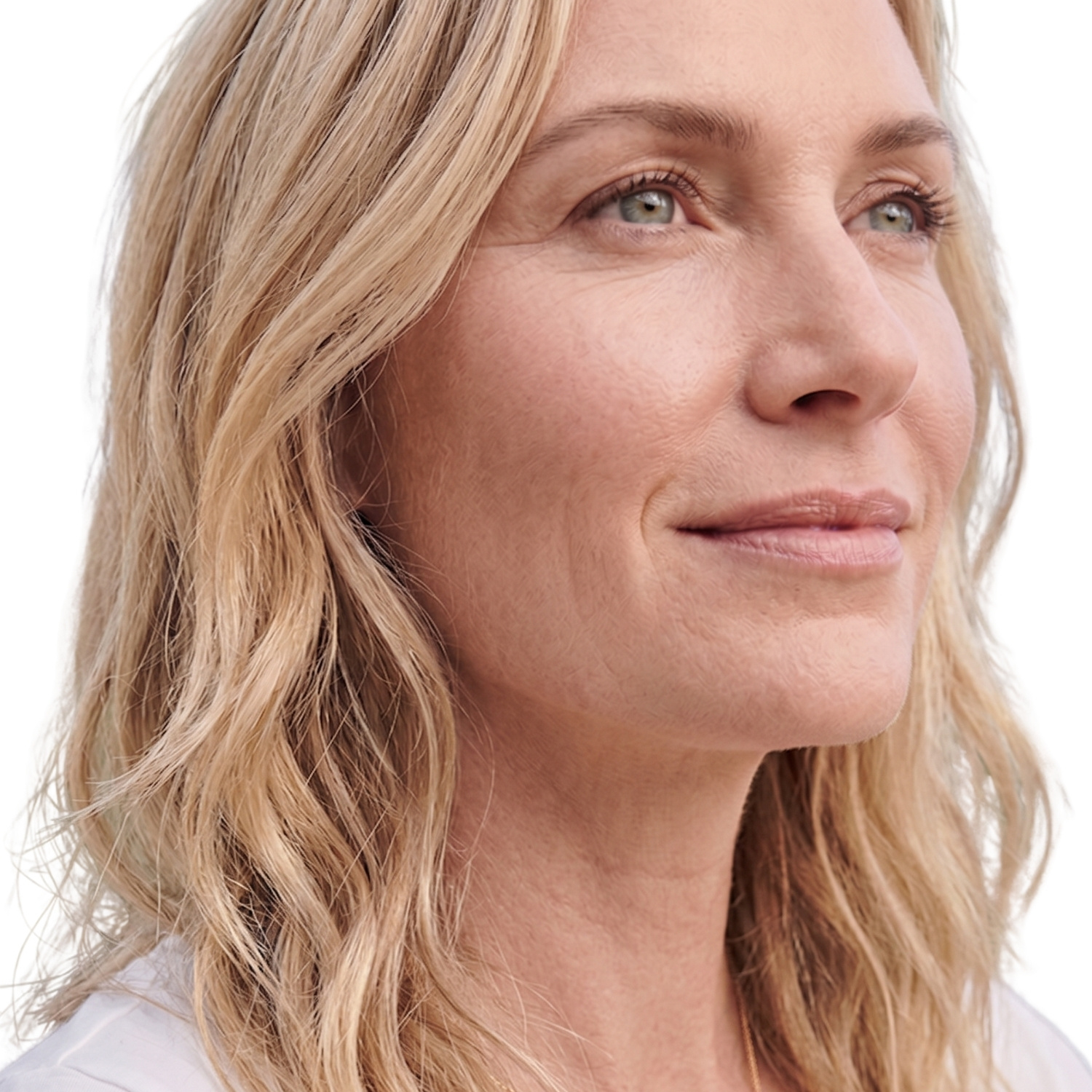 Close-up of a smiling blonde woman looking to the right, with light makeup.